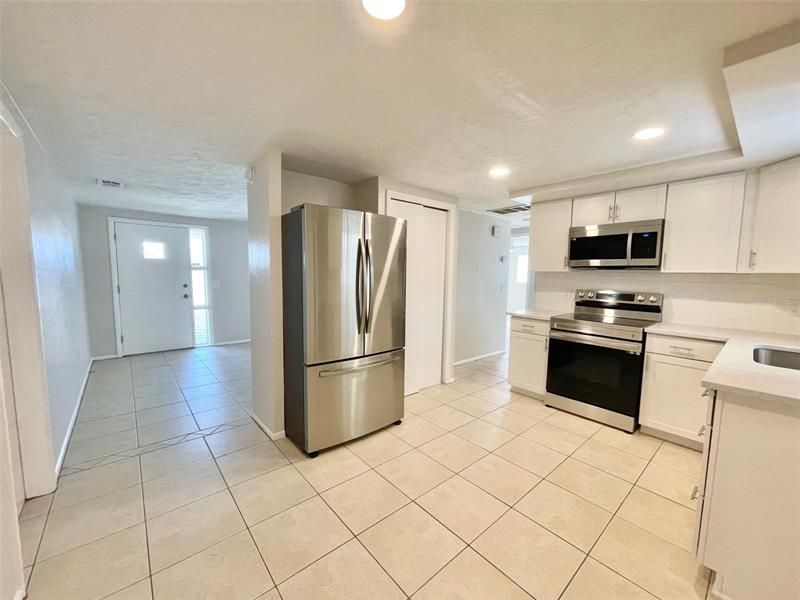 Kitchen toward front of home living room