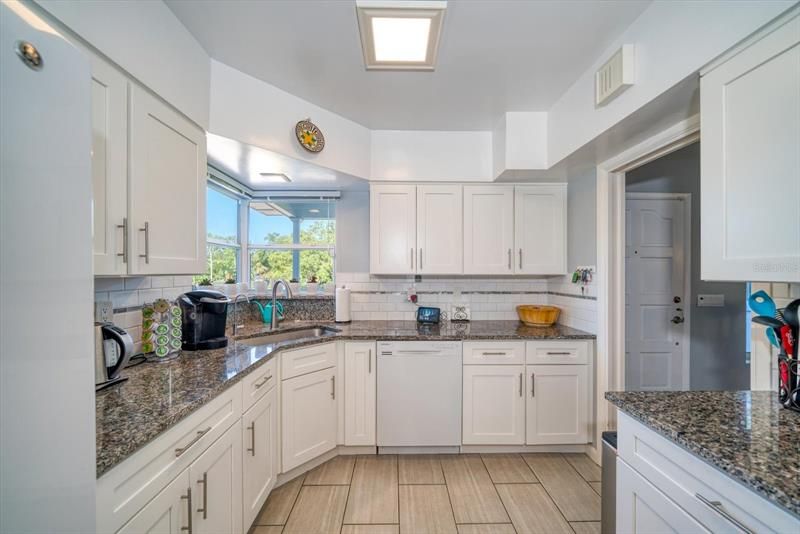Lovely updated kitchen with newer cabinetry, appliances and views overlooking park