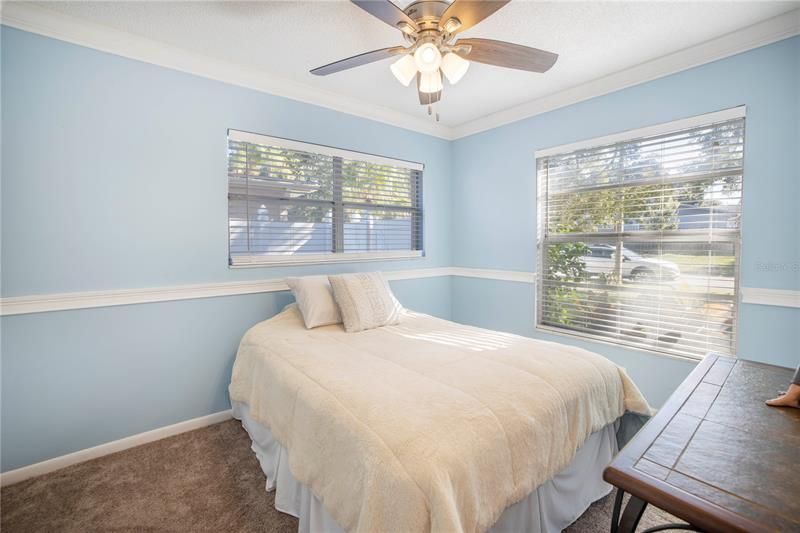 Guest bedroom with crown molding, new carpeting, and double windows for plenty of sunshine!