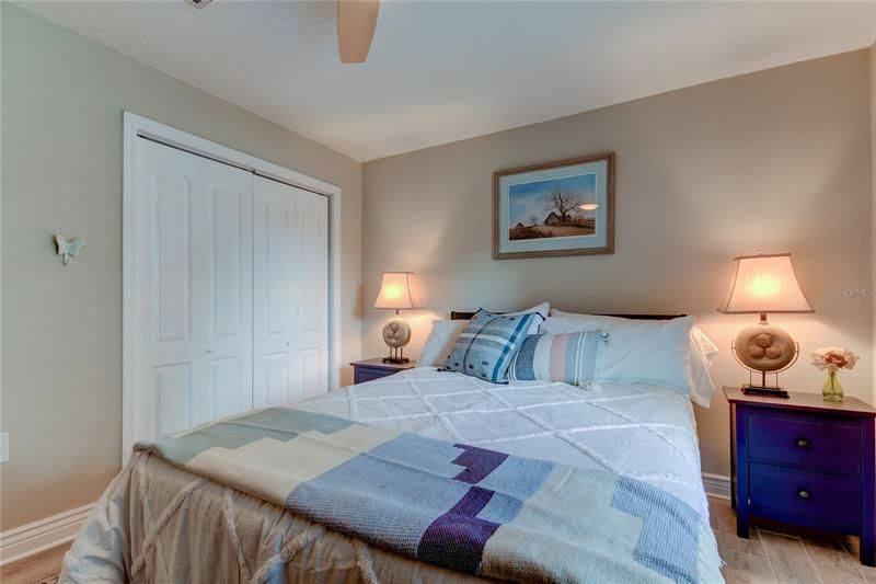 Bedroom #2 Featuring a luxurious Queen size bed, x4 king pillows, Boho bedding w a wood throw