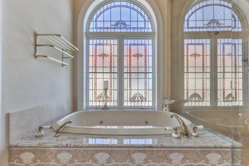 Primary bath with stained glass windows, jacuzzi tub