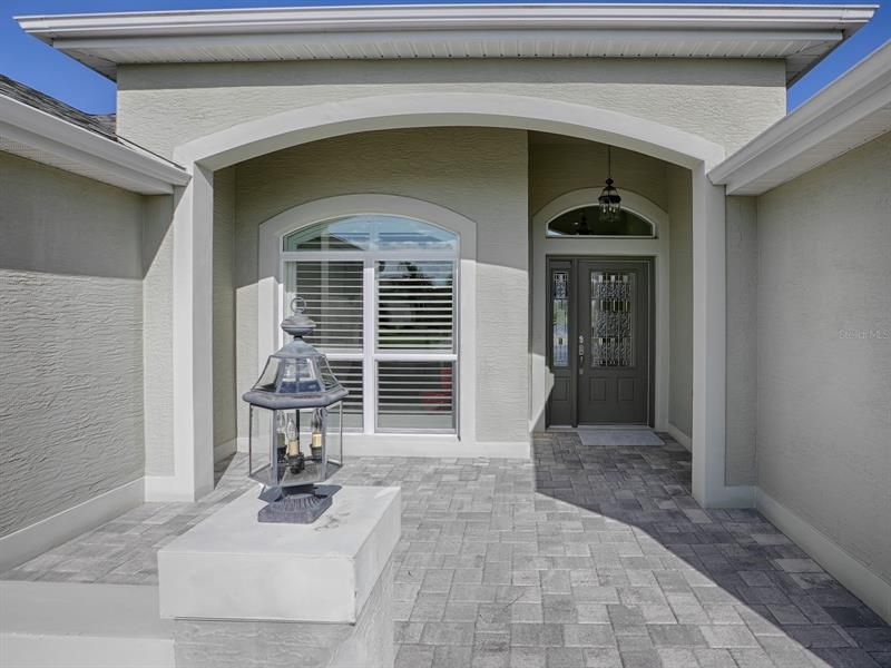 BEAUTIFUL PAVER DRIVEWAY AND WALKWAY LEAD TO YOUR LEADED-GLASS FRONT DOOR ENTRY.