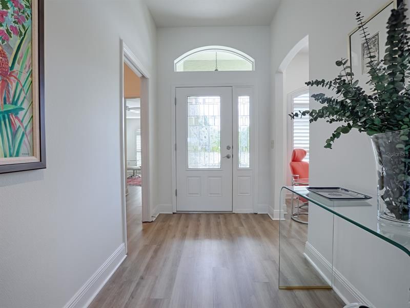 LOVELY LEADED GLASS FRONT DOOR AND SIDELITE WITH LUXURY VINYL PLANK FLOORING THROUGHOUT MUCH OF THE HOME WITH TILE IN THE BATHS, LAUNDRY ROOM AND FLORIDA ROOM!