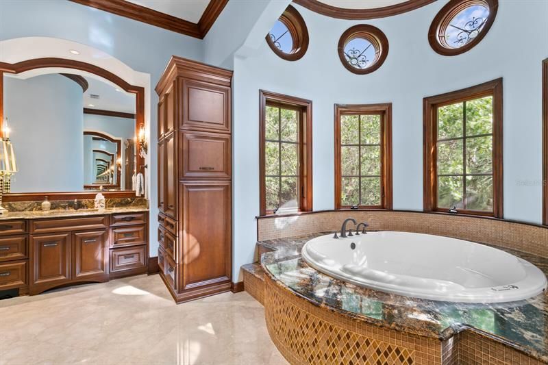 There are two separate sinks areas with storage and two water closets.  This is another view of the soaking tub with lots of privacy from the outdoors