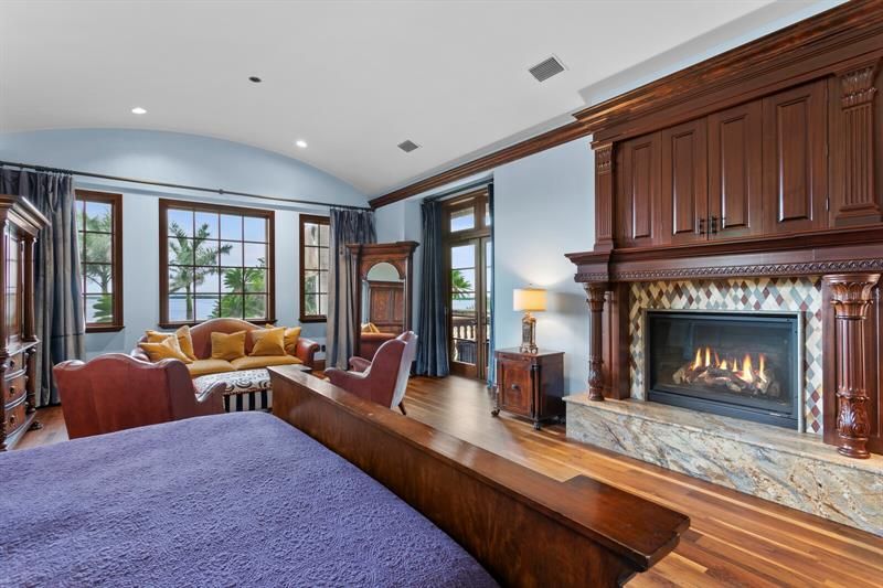 The beautiful Black Walnut wood flooring adds elegance and the propane fireplace with intricate marble facing provides a cozy atmosphere on those rare cold nights in Florida
