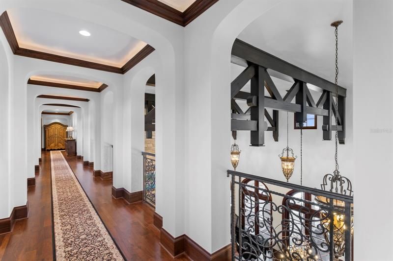 Beautiful curved archways, ceiling trays, cove lighting and the continued intricate iron bannisters show the superior details of the second floor. No expense was spared.  ALL areas were done with quality materials!