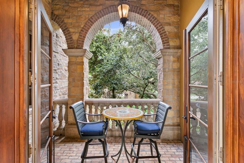Two private balconies of brick and stone are on each side of the front door. Such a lovely private setting if hosting a large party inside