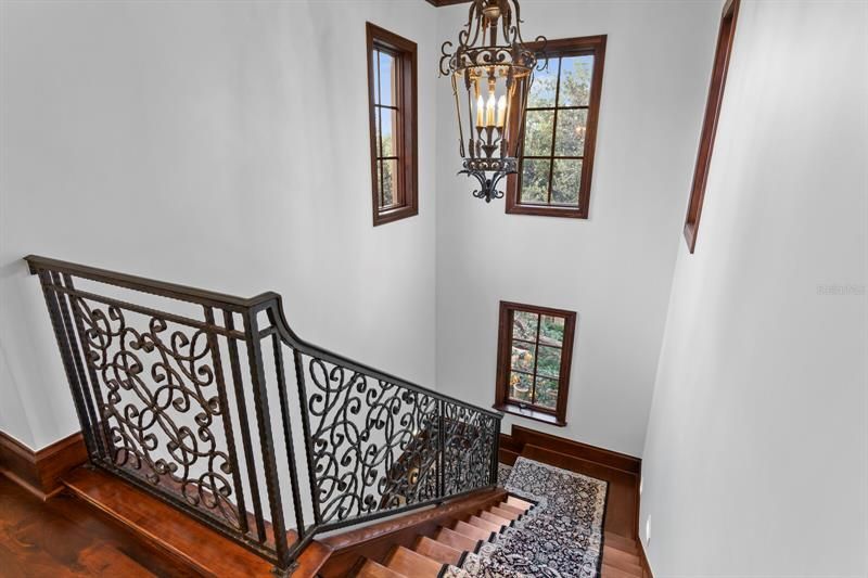 The intricate iron bannister adds to the luxury feeling of this home