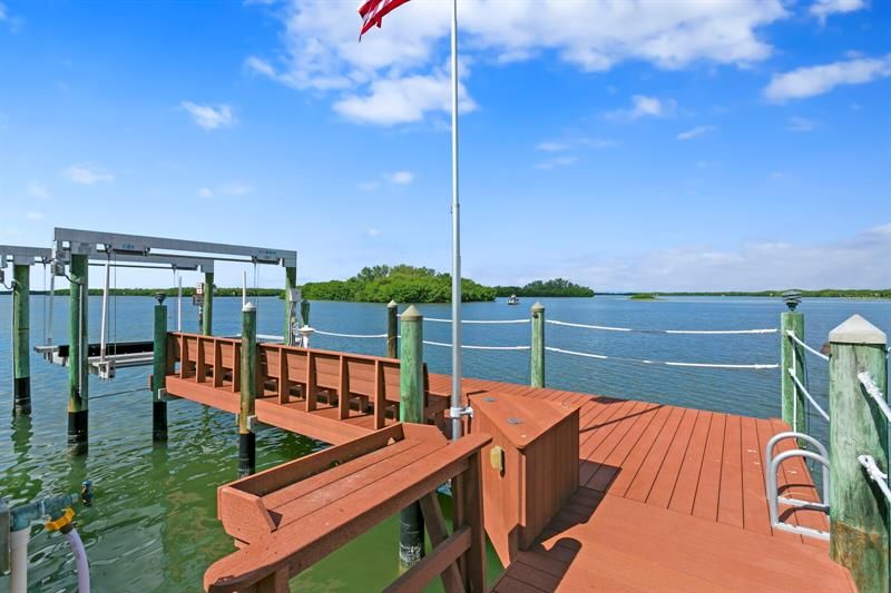 The dock is a Trek Deck with a 12,000 lbs boat lift. It can accommodate up to a 28' bay boat. Power and fresh water supplies including an outdoor fresh water shower.  There are also lights underneath at night to attract fish!