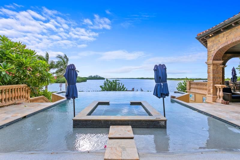 Just beyond the living and dining area is the gorgeous negative edge, saltwater, and heated infinity pool and spa