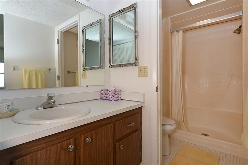Private vanity area separate from lavatory and shower location.