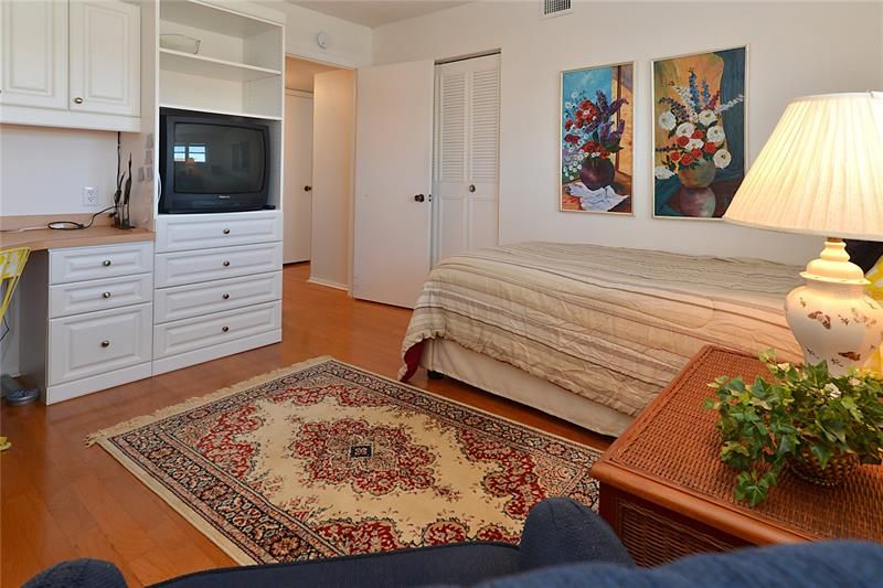 Guest bedroom, currently serving as an additional study, t.v room with single bed. Pecan hardwood floors also carry into this room. Hall bathroom is just off this room for your guest convenience.