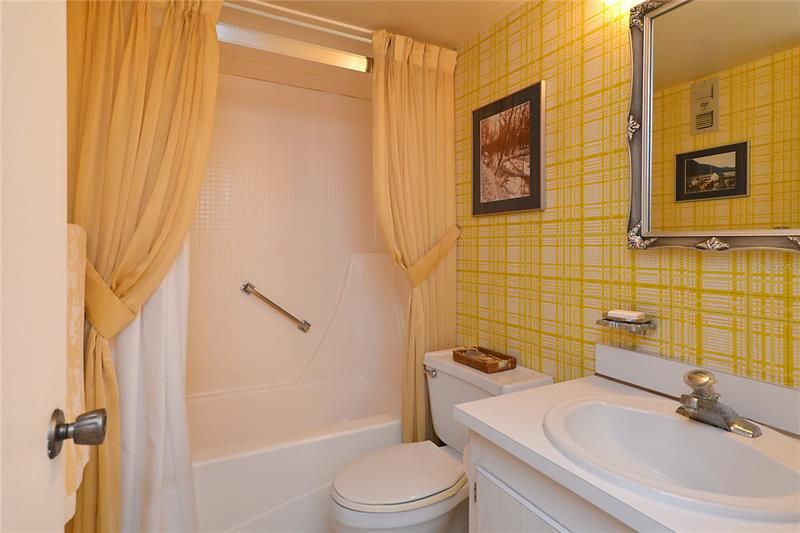 Neutral guest bathroom that is equipped with a shower and bathtub.