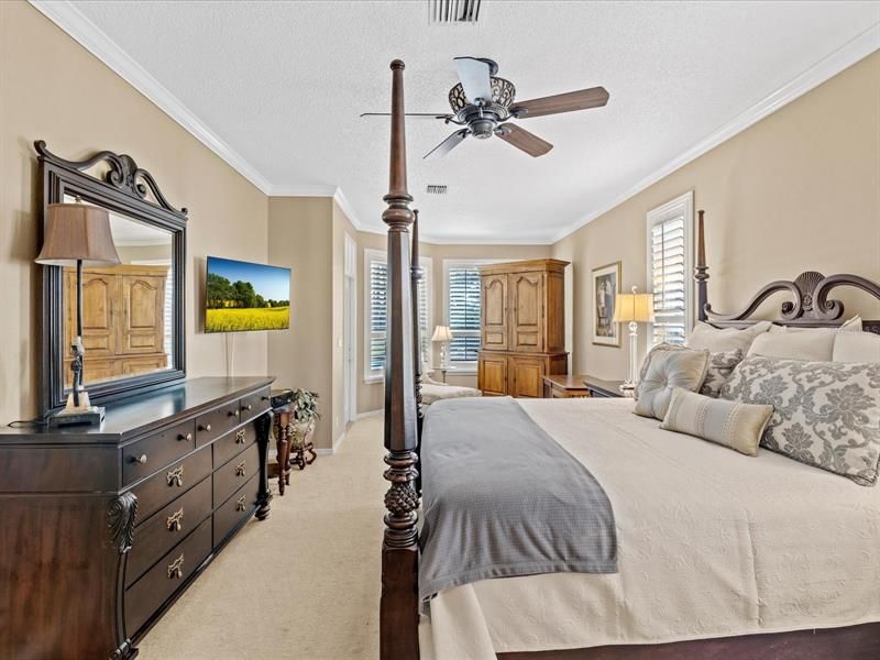 Huge Master Bedroom w/ Sitting Area, Crown Molding, Wood Cased Windows, Plantation Style Shutters, Private Pool Access, (2) Walk in Closets, and Ensuite Bath