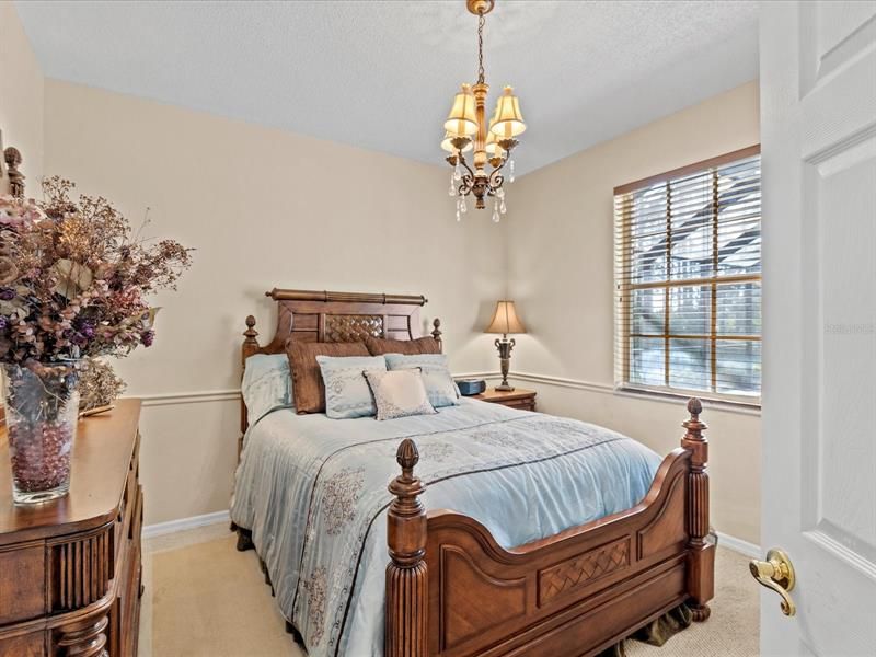 Guest Bedroom #3 w/ Wood Style Blinds, View of the Pool Area, and Walk in Closet