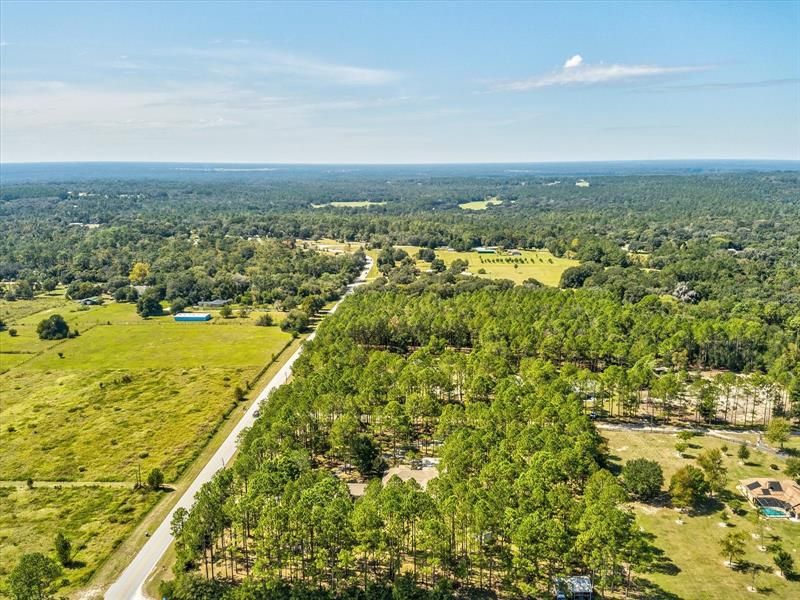 Another Drone Aerial View of the Property and Surrounding Area Looking West