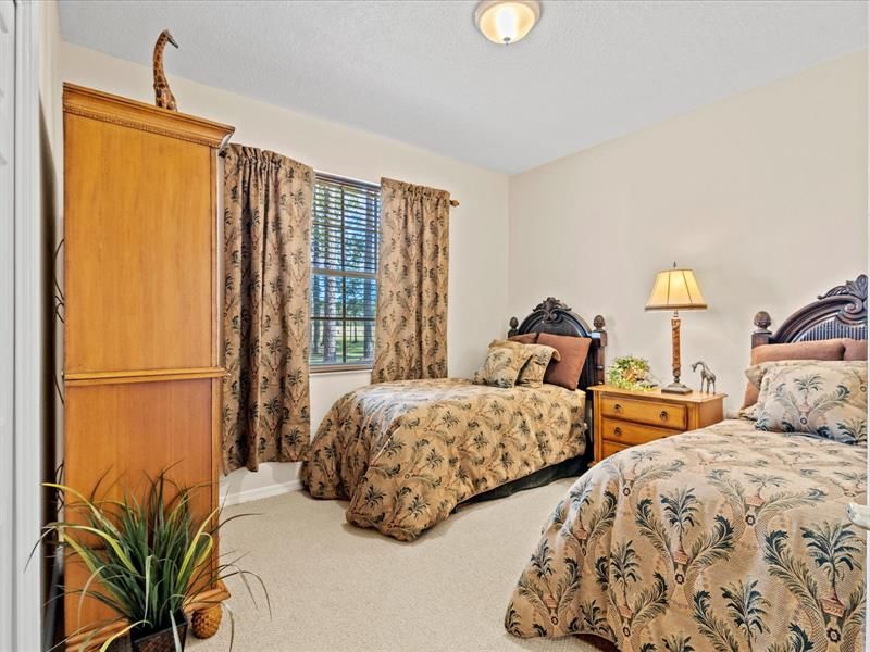 Guest Bedroom #2 w/ Wood Style Blinds, Curtains, View of Backyard, and Walk in Closet