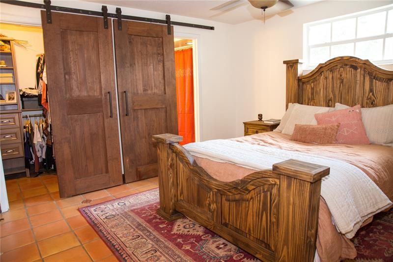 Master bedroom with barn doors to closet and bathroom