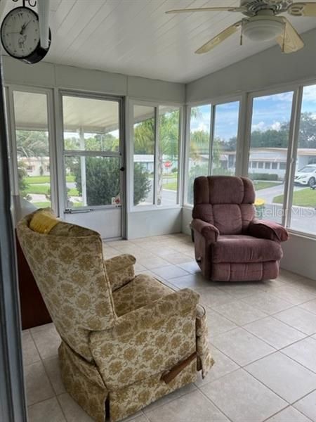 Florida Room with tiled flooring and glass windows