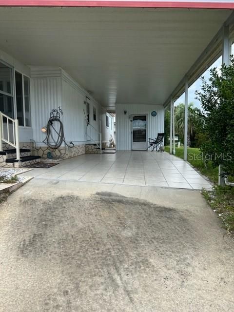 Tiled carport, Breezeway to back of property and storage, laundry room.