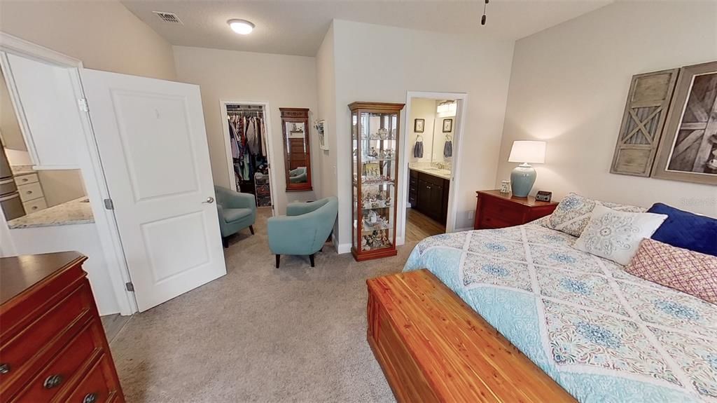 Enjoy a read in the cozy sitting area in the master suite. The WIC is shown at the rear