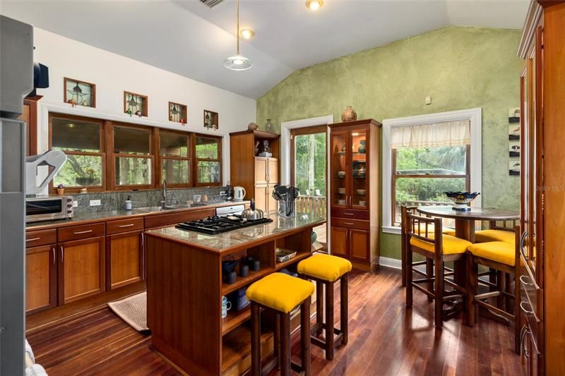 FABULOUS KITCHEN IN MAIN RESIDENCE WITH CHERRY CABINETS, GRANITE COUNTERS, AND BREAKFAST NOOK