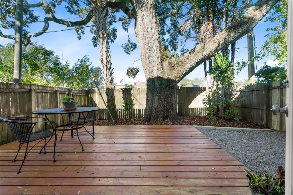 Fenced courtyard with deck