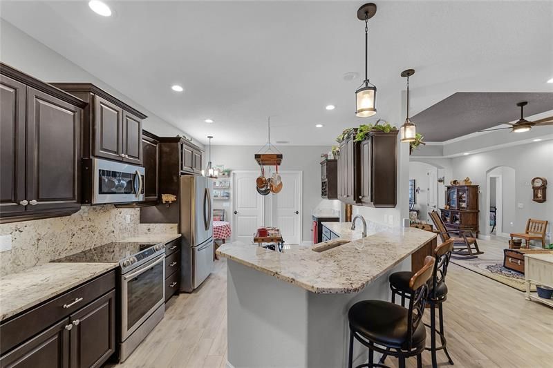 Kitchen with Stainless Steel Appliances, Upgraded Kitchen Cabinets, Granite Countertops & Bar, Pendant Lighting, Recessed Lighting.
