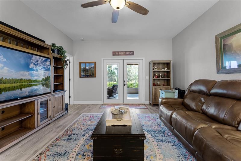 Additional View of Family Room showing French Doors going out to Rear Screened in Covered Patio