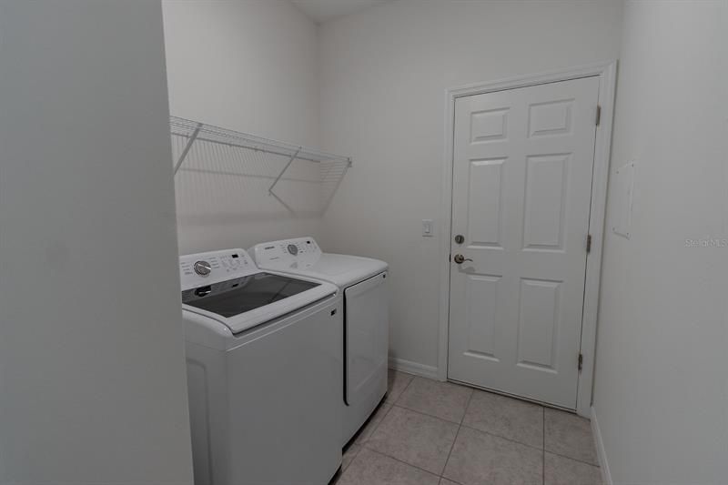Laundry Room into Garage (interior photos from model home which has same finishings as this house)