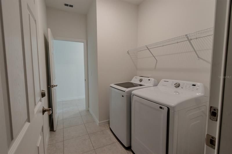 Laundry Room into Hallway (interior photos from model home which has same finishings as this house)