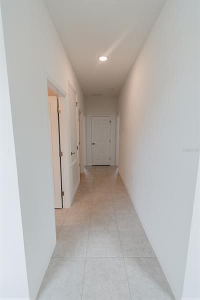 Front Hallway leading to Guest Bathroom and Bedrooms (interior photos from model home which has same finishings as this house)