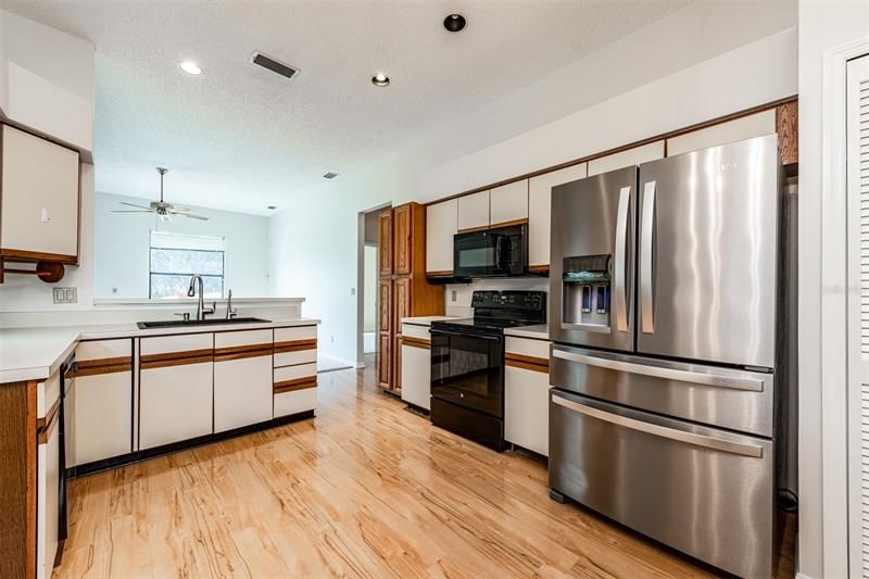 Follow the flow into the KITCHEN which delivers quality appliances, plenty of cabinets for storage, a DINETTE and BREAKFAST BAR for casual dining.
