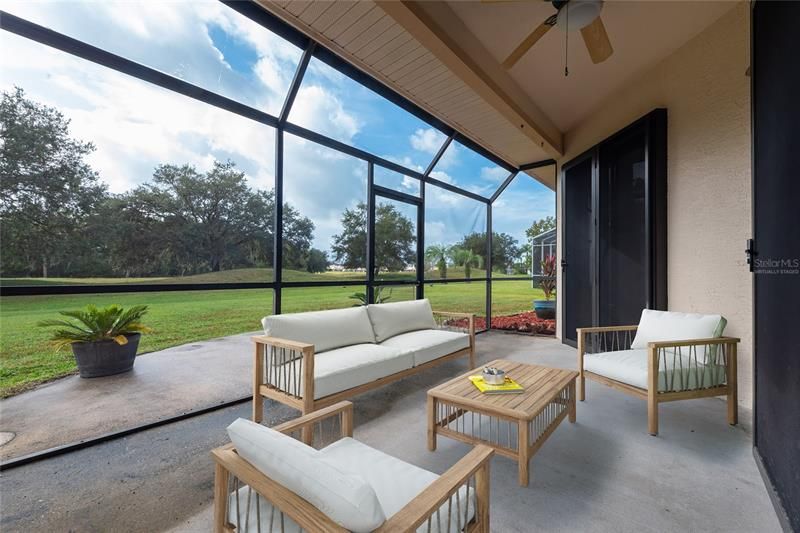 Step out into the SCREENED LANAI, complete with a ceiling fan and perfect for entertaining. Virtually Staged.