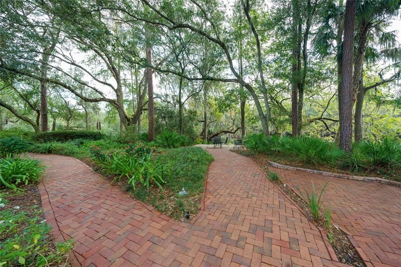 Brick garden path and walkway to deck on river, patio to right