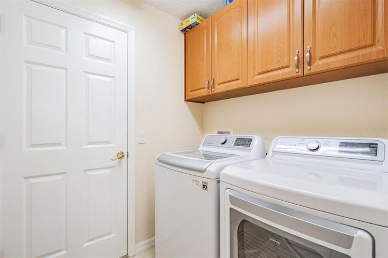 Walk in laundry room with built-in cabinets