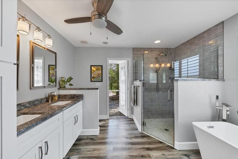 Double vanity with granite and lots of storage in the master bath. enjoy the soaking tub, garden views with access to the pool.