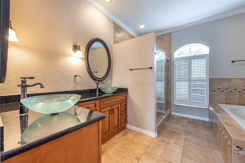 Master bath with dual sinks, garden tub and step in shower with built in bench.