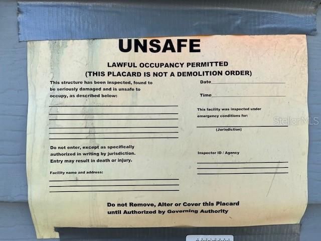 Unsafe Sticker Posted on Property