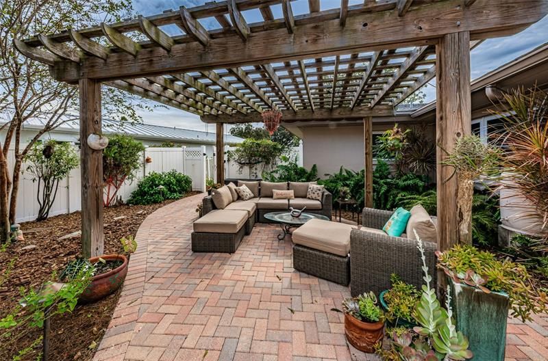 Pergola with comfortable couch seating is the perfect spot for a nap.