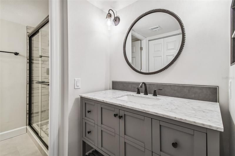 En-suite bathroom vanity offers ample storage.