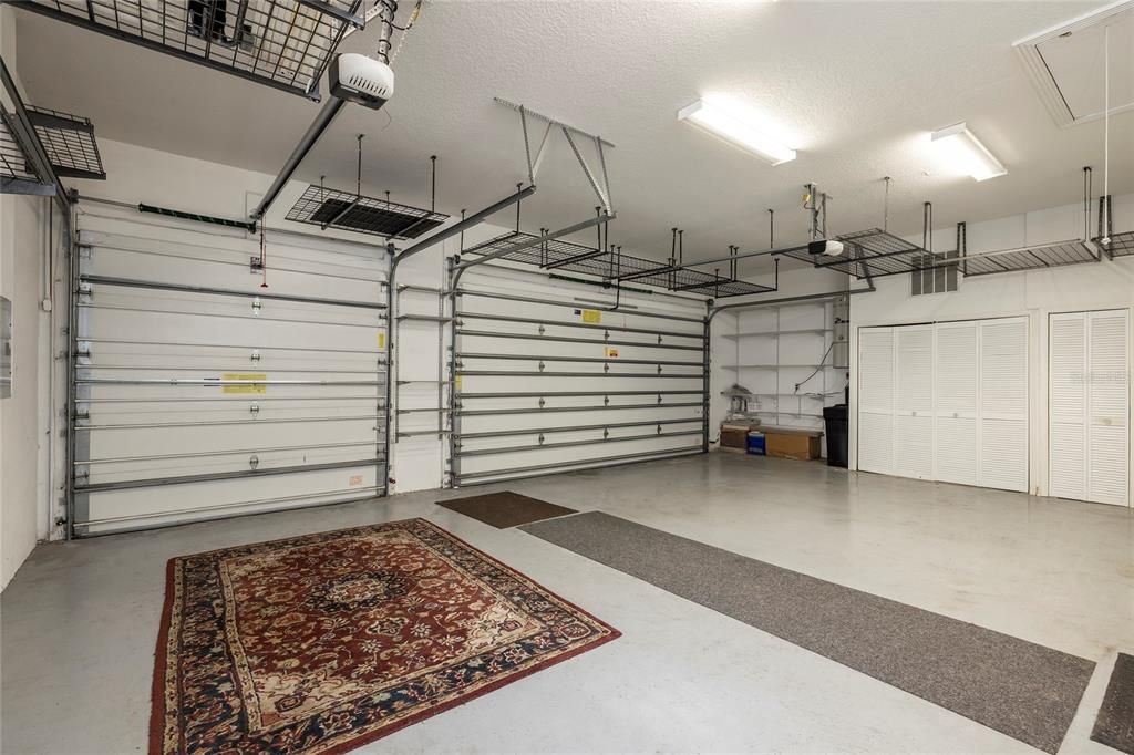 3 Car Garage with overhead storage. A/C units and Water heater in closets and then more storage cabinets not in photo