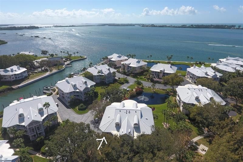 Front aerial view overlooking lake with peek a boo views of Intracoastal