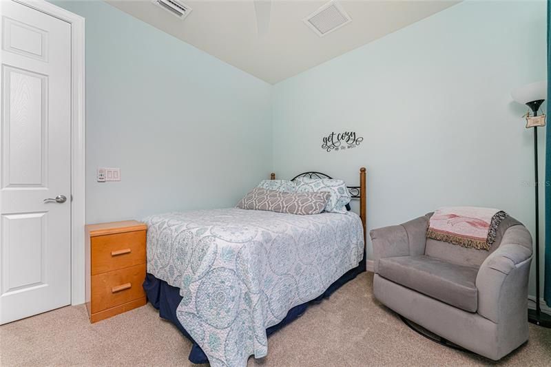 The guest bedroom will accommodate visitors in comfort.
