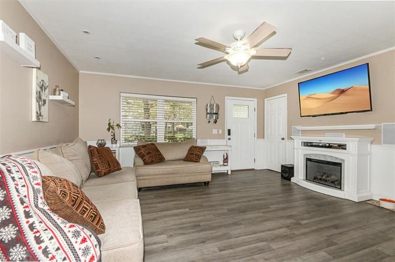 Living room w/ NEW Luxury Vinyl Planking & Wainscoting Throughout, Built in Surround Sound & Electric Fireplace