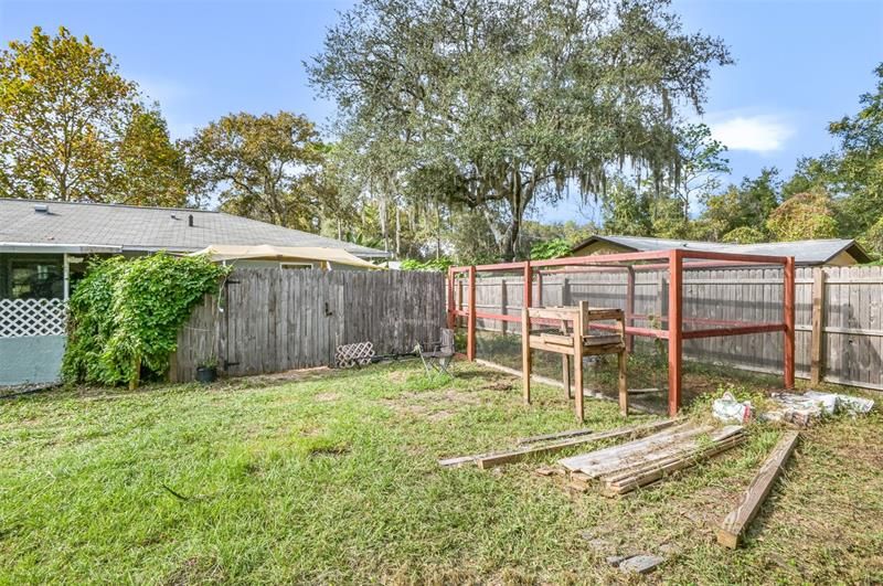 Chicken Run w/ the coop being behind the wood privacy fence