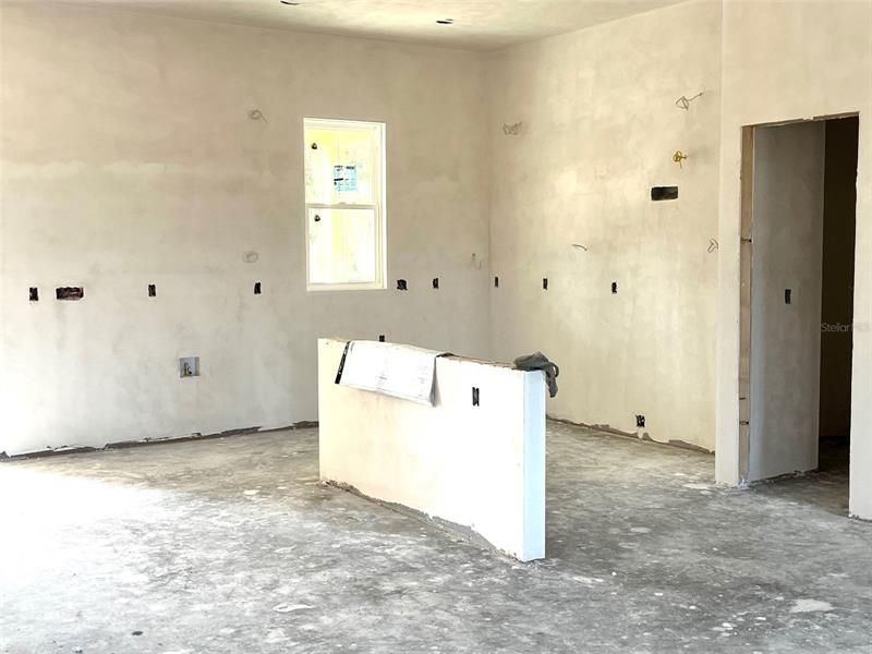 Kitchen with island in drywall stage