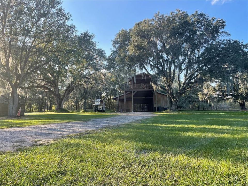 Barndominium with 6 stalls, 2 bed, 3 bath  surrounded by spectacular grandfather oaks.