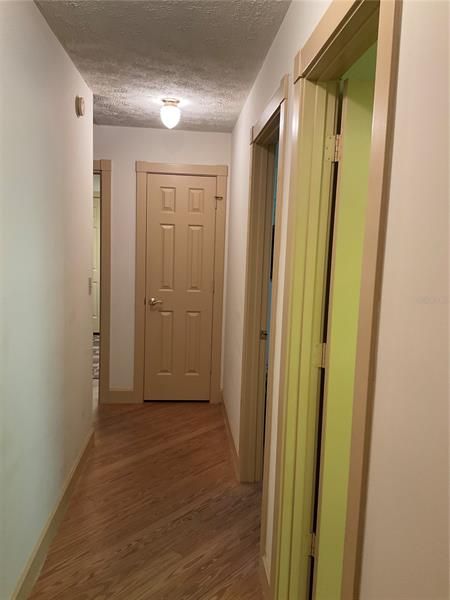 Hallway to split bedrooms with another linen closet at end of the hall
