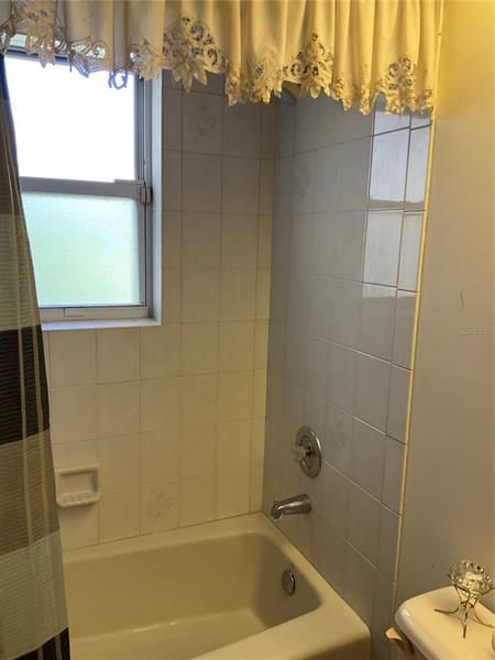 Bathroom two with tiled shower and tub
